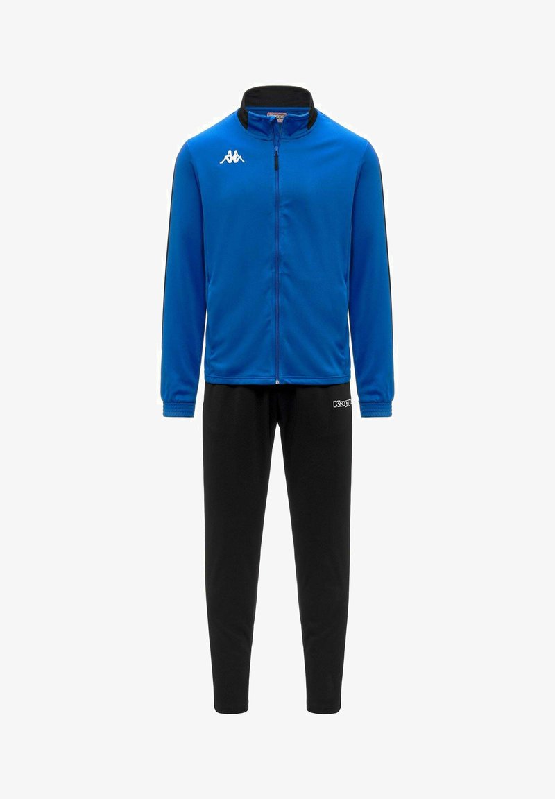 Ensemble de sport pour homme avec une veste zippée bleue ornée d'un petit logo blanc sur la poitrine et un pantalon noir fuselé avec un logo sur la hanche.