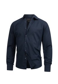 Marineblå langærmet skjorte i et glat stof med button-down krave, frontknapper og en let løs pasform. Ingen mønstre eller detaljer synlige.