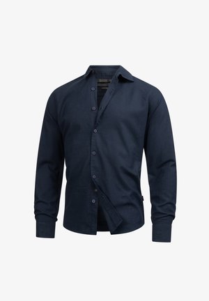 Granatowa koszula z długim rękawem, wykonana z gładkiego materiału, z kołnierzykiem zapinanym na guziki, guzikami z przodu i lekko luźnym krojem. Brak widocznych wzorów lub akcentów.