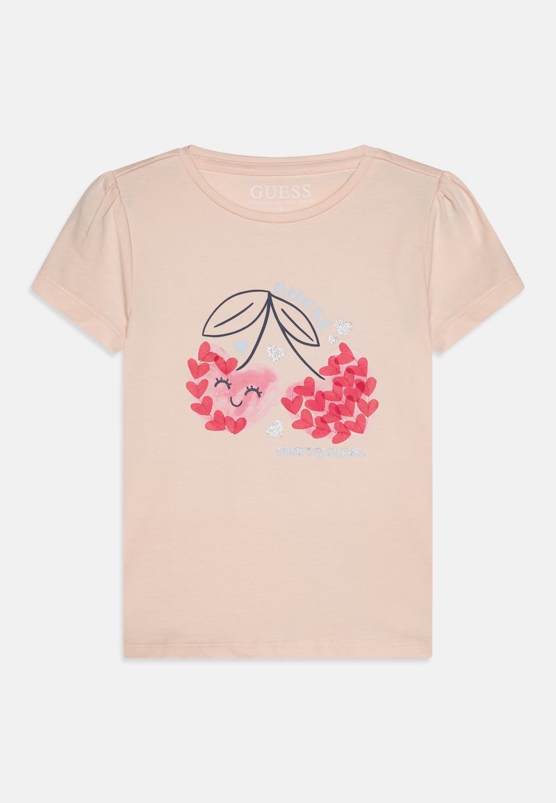 Tricou scurt din bumbac organic, de culoare piersiciu, cu un grafic de cireșe realizat din inimi roz și frunze, având accente de sclipici.