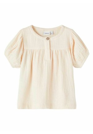 Top in cotone color pesca chiaro con maniche corte a sbuffo, pieghe orizzontali, scollatura rotonda e chiusura con bottoni sul davanti.