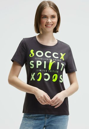 Dark gray cotton t-shirt featuring large neon green graphic text. Short sleeves and a rounded neckline. Casual fit with a soft texture.