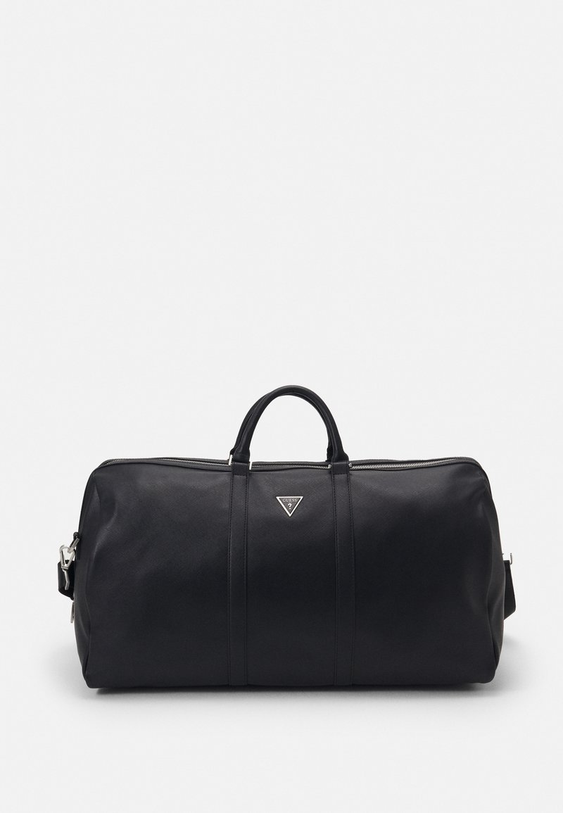 Sac polochon en cuir noir avec poignées supérieures, fermeture éclair et logo Guess triangulaire au centre avant.