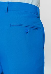 Erksin sinised püksid, millel on lame esikülg, küljetaskud, nööbiga sulgur ja väike tagatasku. Valmistatud siledast kangast, millel on struktureeritud istuvus.