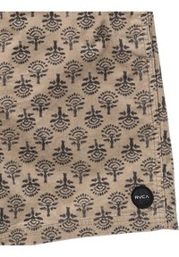 Tissu beige avec un motif floral noir répétitif. Présente un logo RVCA noir rond sur le bord. Texture douce et design structuré.