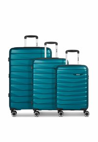 Drie harde koffers in teal, met een golfpatroon, een gladde textuur, uitschuifbare handvatten en vier draaibare wielen voor mobiliteit.