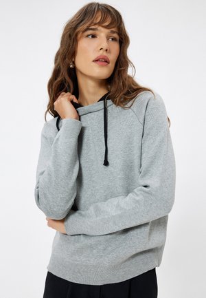 Grijze sweatshirt met een hoodie met trekkoord, geribbelde manchetten en tailleband. Zachte textuur en een ontspannen pasvorm, met zwarte trekkoordaccenten.