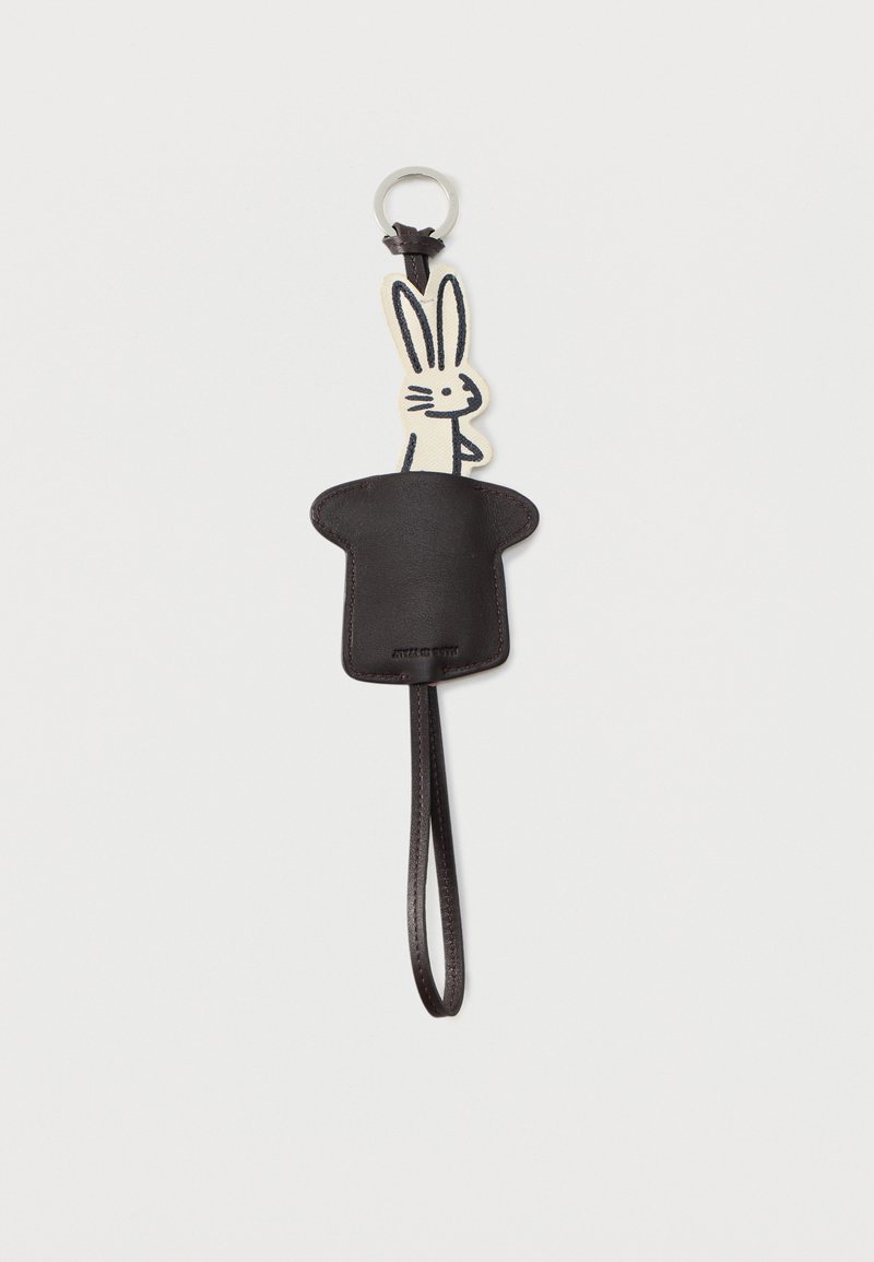 Bracelet de poignet en cuir noir attaché à un support en forme de chapeau de magicien, d'où émerge un lapin de dessin animé blanc.