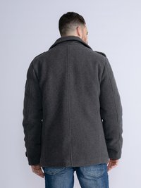 Gray wool coat with a notched collar, visible seams, and a straight cut. Features side pockets and is styled for a relaxed fit.