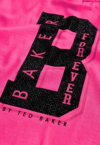 Rosa stof med et stort sort paillet-tal "8" samt teksten "BAKER FOREVER" i kontrastfarvet pink. Glat tekstur med markante accenter.
