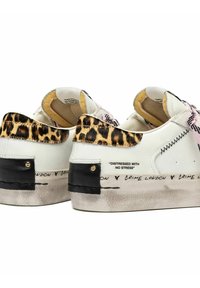 Sneakers bianchi con dettagli in stampa leopardata, lacci rosa, toppini neri sul tallone e la scritta "DISTRESSED WITH NO STRESS" e "CRIME LONDON" sul bordo della suola.