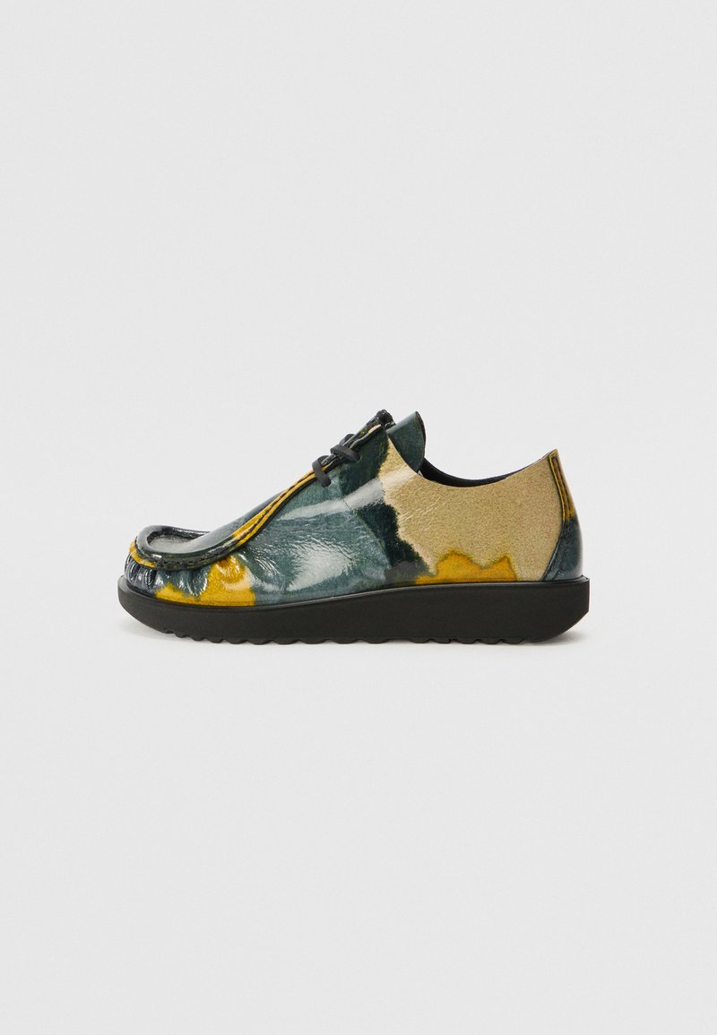 Többszínű bőr cipők sima textúrával, zöld és sárga absztrakt mintázattal, kerek orral és fekete gumitalppal.