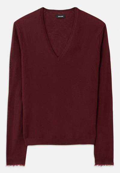 Burgundy V-kaelusega sviiter pehmest, tekstuuriga kangast. Omab pikki varrukaid ja veidi kulunud serva. Lihtne disain, nähtavaid mustreid pole.