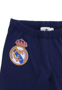 Marinemarine blauwe sweatpants met een geborduurd Real Madrid-logo met een kroon. Elastische tailleband en een zachte stoftextuur.