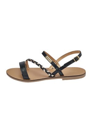 Black leather sandals featuring a braided strap design, flat sole, and adjustable ankle strap with a gold-tone buckle detail.