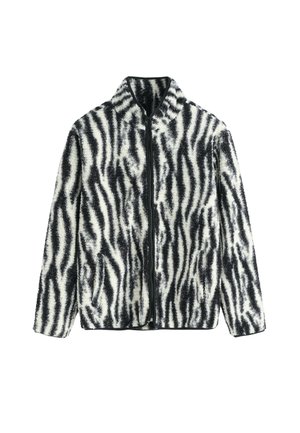 Veste en fausse fourrure avec un motif de rayures zèbre noir et blanc, dotée d'une fermeture éclair sur le devant et d'un col montant, fabriquée à partir d'un matériau doux et texturé.