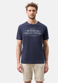 Granatowa bawełniana koszulka z okrągłym dekoltem, z białym napisem "oryginalne ZBIORY ZACHODÓW SŁOŃCA" na piersi.