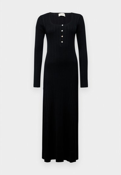 Black ribbed long-sleeve maxi dress with a square neckline and five decorative buttons at the front, featuring a form-fitting shape and smooth texture.