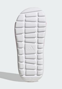 Zunanji del čevlja Adidas v teksturirani beli gumi. Ima mrežno vzorčenje z majhnimi šestkotnimi vdolbinami ter vidnim logotipom na sredini.