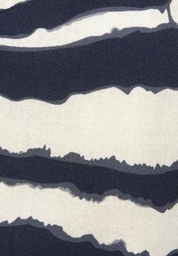 Fabric featuring alternating wavy stripes in navy and cream, with a textured surface. The pattern is bold and graphic, creating visual interest.