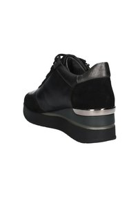 Sneaker nera con un mix di pelle liscia e suede. Presenta un tacco basso con accenti in argento. Dettagli con lacci e pannello posteriore testurizzato.