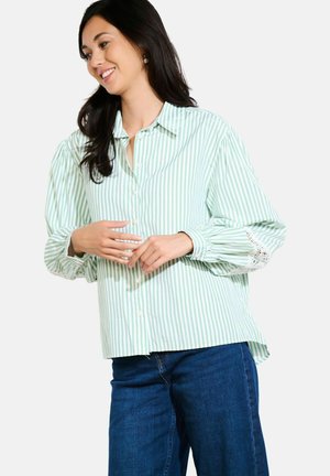 Green and white striped button-up shirt with a collared neckline and puff sleeves, featuring lace detailing at the cuffs and a relaxed fit.