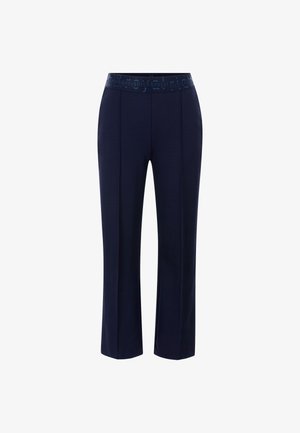 Pantalons bleu marine en tissu doux, dotés d'une ceinture élastique à motifs et de deux détails de couture verticaux à l'avant.