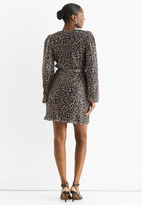 Leopard-print dress with long puff sleeves, cinched waist, and a short length. Made from a textured fabric with a shiny finish.