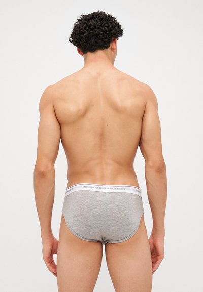 Graue Baumwollslips mit einem enganliegenden Design, versehen mit einem weißen Bund, der die Markenbezeichnung "DSQUARED2" trägt. Modell von hinten gezeigt.