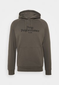 Sweat à capuche vert kaki en tissu doux avec une poche kangourou, une capuche à cordon de serrage, et le texte "Peak Performance Est.1986" en noir.