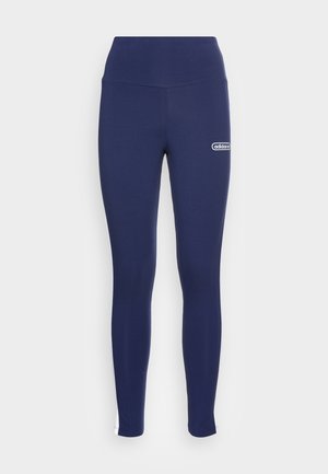 Marineblå leggings laget av elastisk stoff med høy midje. Har en hvit logo på låret og en sidespalte ved ankelen.