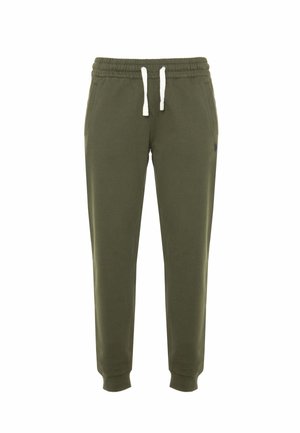 Pantaloni della tuta verde oliva realizzati in morbido misto cotone. Presentano un elastico in vita con cordoncino e caviglie a costina. Logo discreto sul lato.