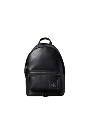 Black leather Calvin Klein backpack with front zip pocket and top handle against a white background.