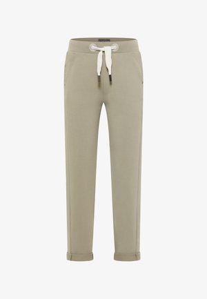 Svetlo béžové tepláky vyrobené z jemného materiálu, s elastickým pásom a bielou šnúrkou, bočnými vreckami a rolovanými manžetami.