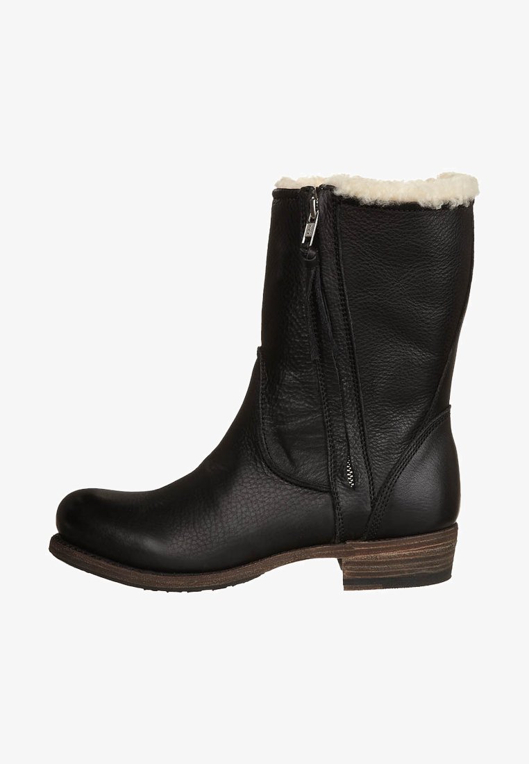 Black leather ankle boot with a textured finish, side zipper, and a soft, white faux fur cuff. Sturdy low heel, rounded toe design.