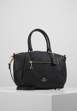 Zwarte leren Coach handtas met gouden rits en logo, dubbele handvatten en afneembare schouderriem op een wit voetstuk.
