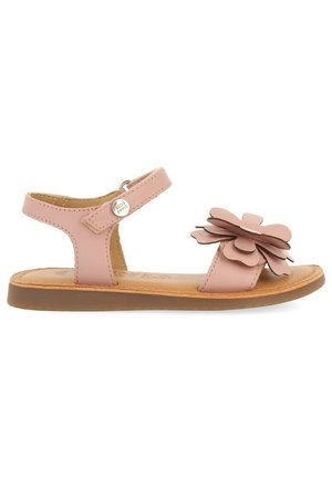 Roze leren sandalen met een bloemenaccent, verstelbare enkelriem, platte zool en bruine textuurzool. Geschikt voor casual wear.