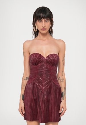 Vestido burdeos sin tirantes con pliegues verticales, corsé estructurado y falda acampanada, que presenta una textura suave y costuras definidas.