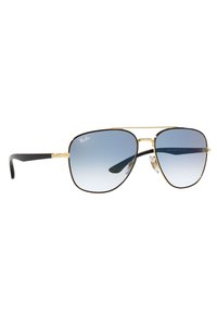 Occhiali da sole Ray-Ban aviator con montatura in metallo dorato, lenti blu sfumate e estremità auricolari nere. Presentano un doppio ponte e naselli regolabili.