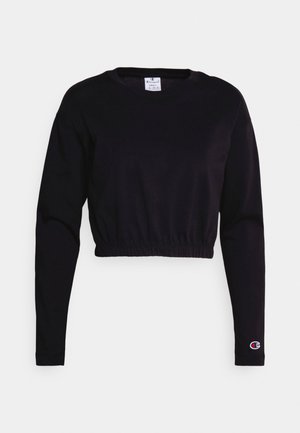 Sweatshirt noir court en coton doux, avec des manches longues, un ourlet froncé et un petit logo brodé sur la manche gauche.