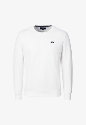 Valkoinen, pitkähihainen pyöreäkauluksinen collegepaita, jossa ribbineulotut hihansuut ja helma sekä vasemmassa rinnassa pieni laivastonsininen logo.