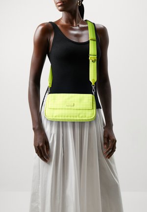 Neon yellow crossbody bag with a textured finish, featuring a rectangular shape and adjustable strap. Contrasting hardware accents.