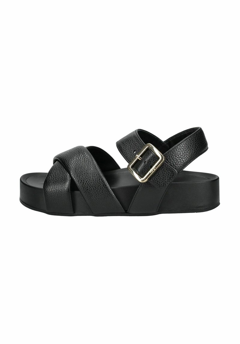 Schwarze Leder-Sandale mit Kreuzriemen und seitlicher Schnalle, mit flacher Plateau-Sohle und strukturierter Oberfläche.