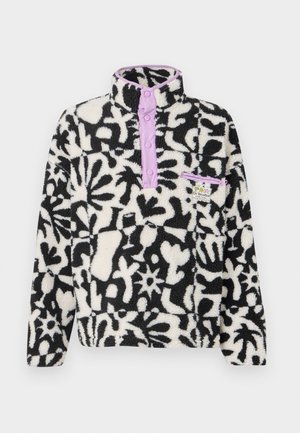 Fleece pullover with black and white floral pattern, purple snap-button placket, high collar, and a small front pocket with logo tag.