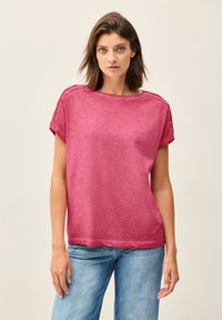 Fuchsia short-sleeve t-shirt in a relaxed fit, crafted from soft fabric with a subtle texture. Features rolled sleeves and a wide neckline.