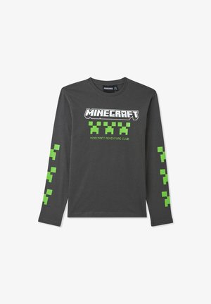Koszula z długim rękawem w ciemnoszarym kolorze, z logiem "Minecraft" w białych i zielonych wzorach w klocki na rękawach. Klasyczny dekolt typu crew neck.