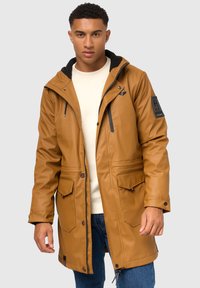 Braune, wasserdichte Parkajacke mit einer schwarzen, fleecegefütterten Kapuze, Reißverschluss vorne, zwei großen Fronttaschen und schwarzen Akzentdetails.