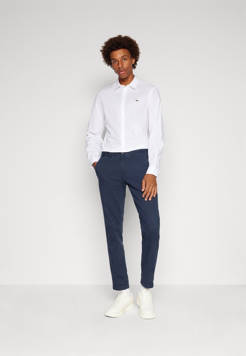 slim fit dress slacks Lacoste Black Men's Slim Fit Movement Polo, US Small