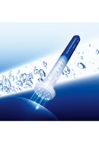 Applicateur transparent avec accent bleu, doté d'un embout texturé, posé sur un fond dégradé bleu avec des gouttes d'eau.