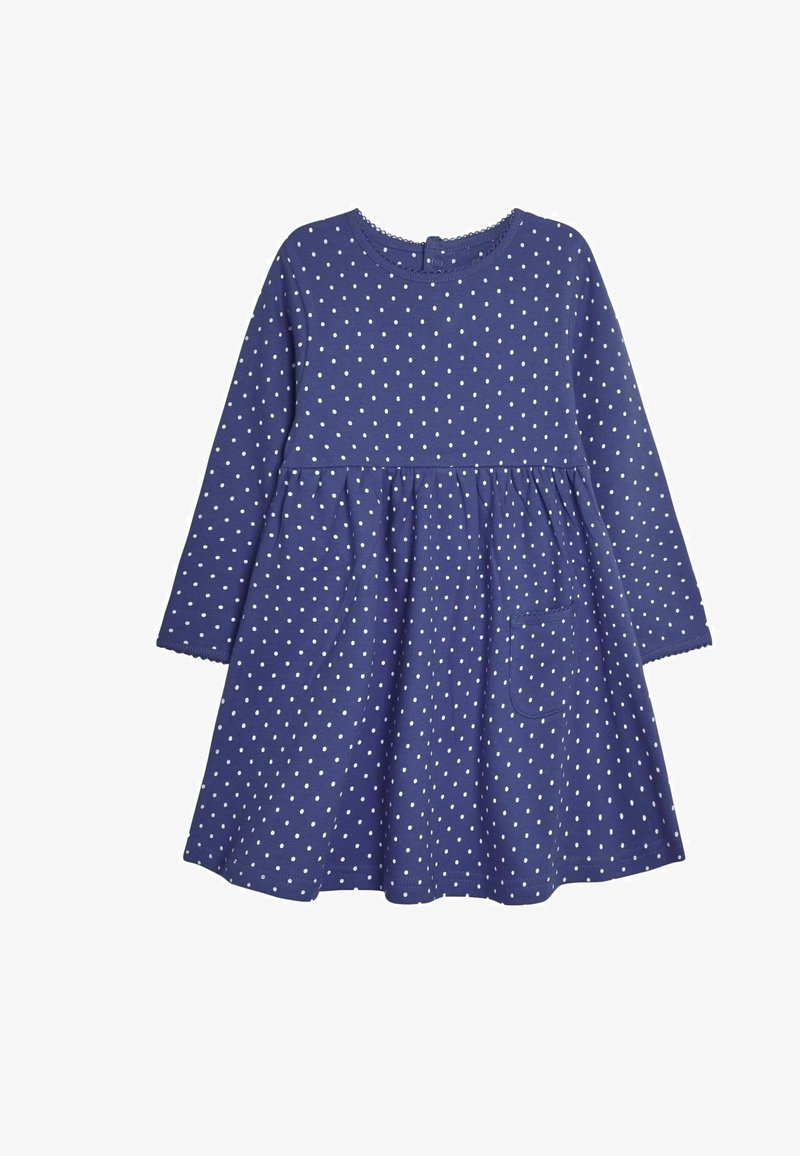 Kratka obleka z dolgimi rokavi iz temno modrega bombaža s belimi pikami, nabranim krilom in majhnim žepom na levem boku. Gumbasta zaponka na hrbtni strani.